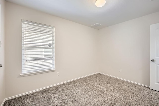 carpeted spare room with baseboards