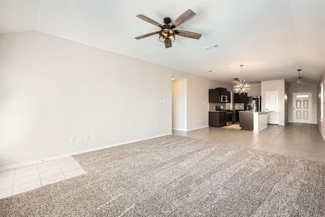 unfurnished living room with light tile patterned floors, light colored carpet, ceiling fan with notable chandelier, visible vents, and vaulted ceiling