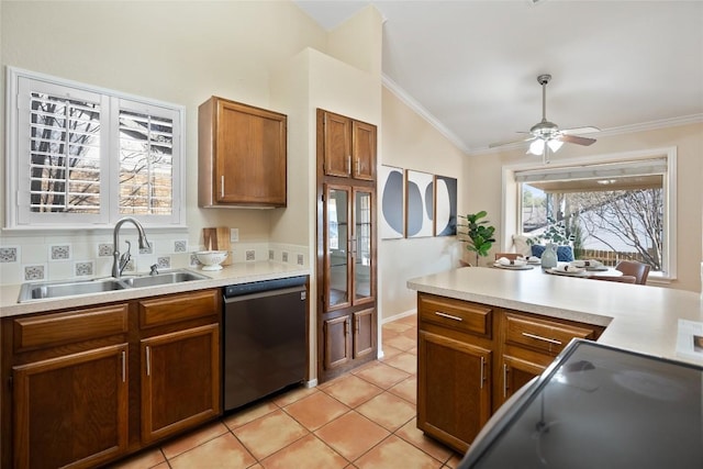 kitchen with brown cabinets, a wealth of natural light, ornamental molding, a sink, and dishwasher