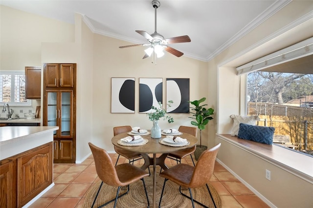 dining area with ornamental molding, a wealth of natural light, and light tile patterned floors