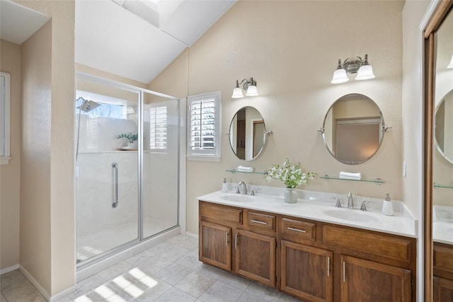 bathroom with lofted ceiling, a shower stall, double vanity, and a sink