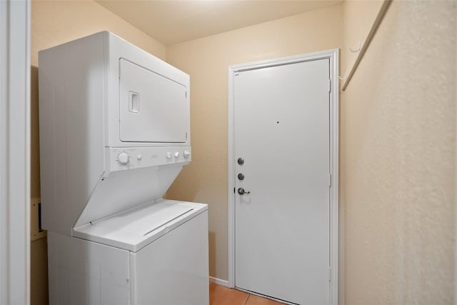 clothes washing area featuring laundry area and stacked washer / drying machine