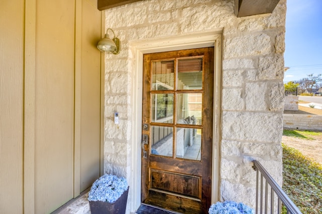 property entrance featuring stone siding