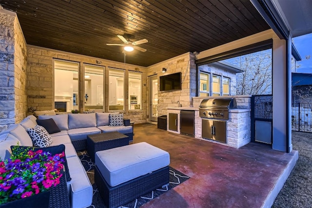 view of patio with an outdoor hangout area, an outdoor kitchen, area for grilling, and a ceiling fan