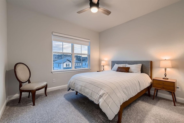 bedroom featuring light carpet, ceiling fan, and baseboards