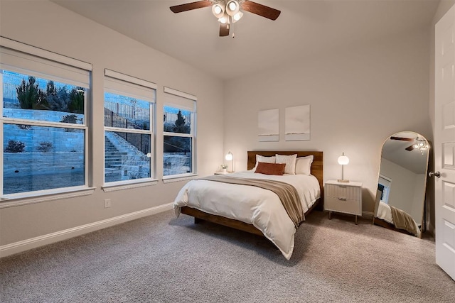 bedroom with carpet floors, a ceiling fan, and baseboards