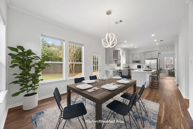 dining area with dark wood-style floors, visible vents, and ornamental molding