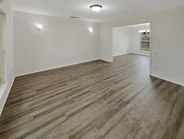 1602 Wildwood Dr, Round Rock, TX 78681 - spare room with dark wood finished floors, a chandelier, and baseboards