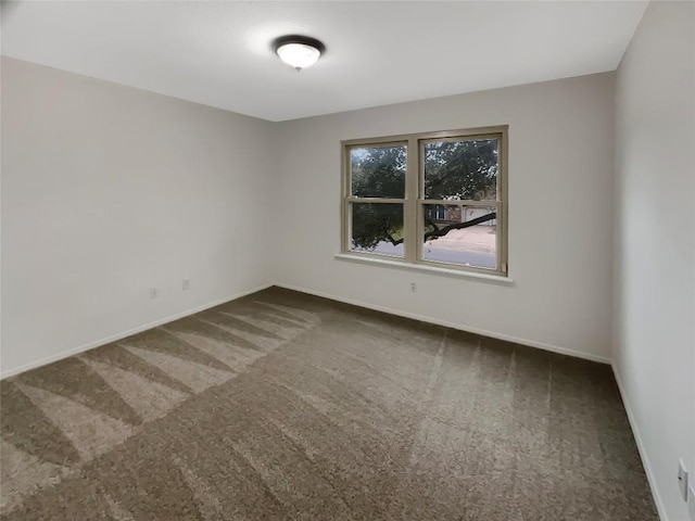 carpeted empty room with baseboards