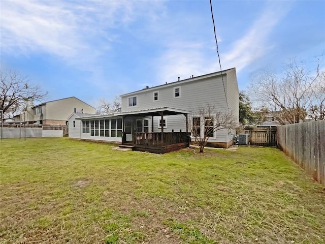 back of house featuring a fenced backyard, central air condition unit, a sunroom, a yard, and a wooden deck