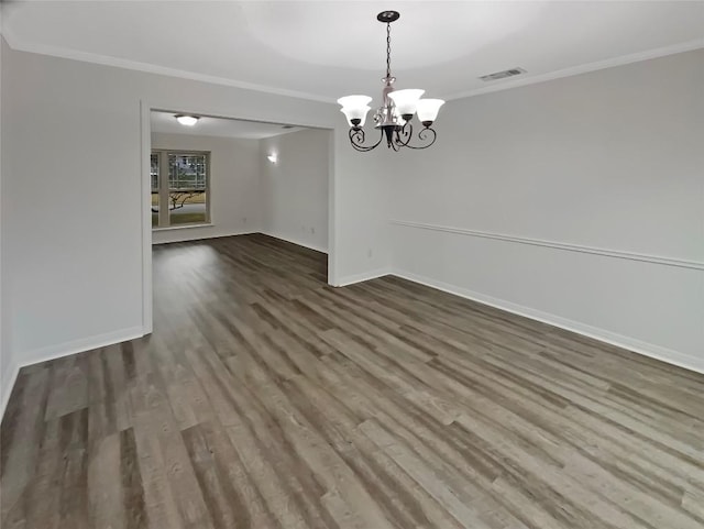 unfurnished dining area with baseboards, visible vents, crown molding, and wood finished floors