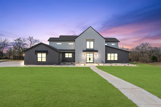 modern farmhouse style home with roof with shingles, board and batten siding, and a front yard