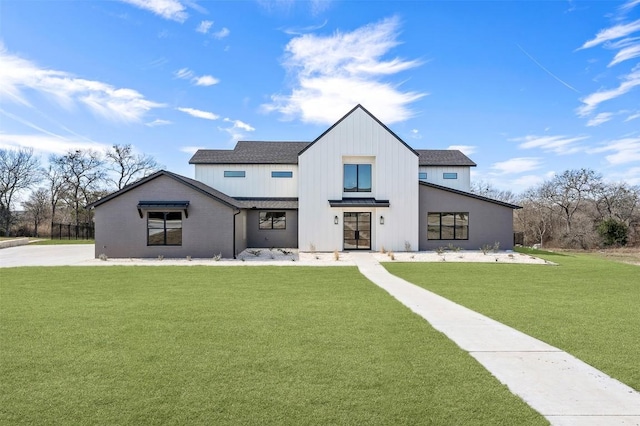 modern farmhouse style home with roof with shingles and a front yard