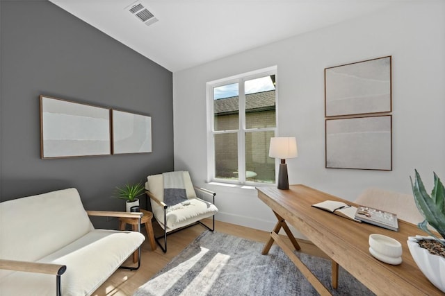 office area featuring wood finished floors, visible vents, and baseboards