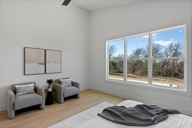 living area featuring light wood-type flooring and baseboards