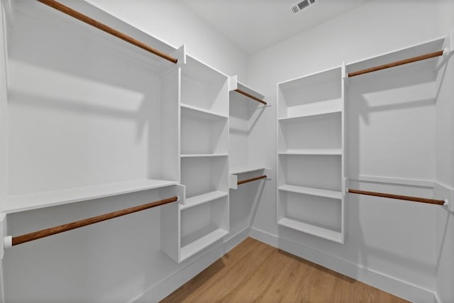 spacious closet with light wood-type flooring and visible vents