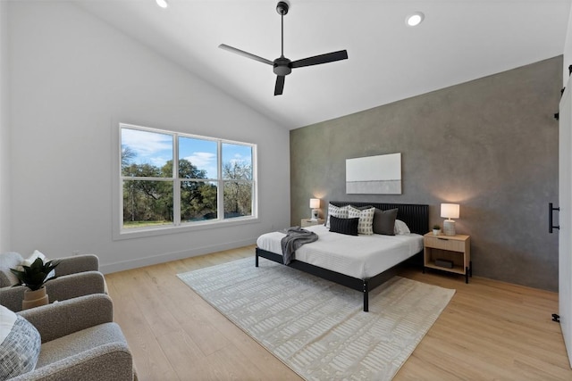 bedroom with ceiling fan, recessed lighting, an accent wall, baseboards, and light wood-style floors