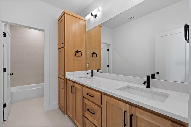 bathroom featuring tile patterned flooring, visible vents, a sink, and double vanity