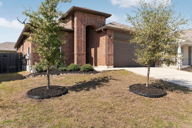 view of front facade featuring a front yard, brick siding, driveway, and fence