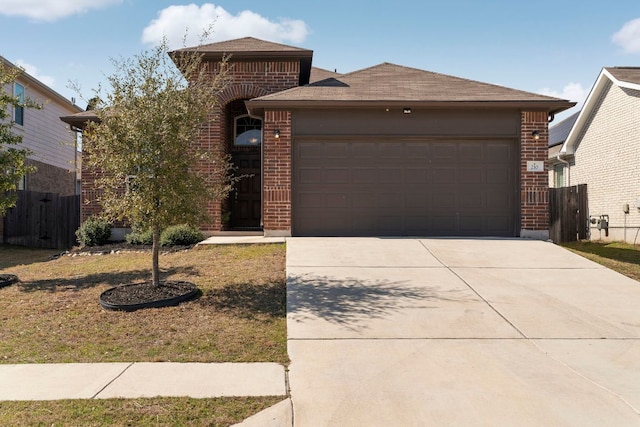 view of front of property with concrete driveway, brick siding, and an attached garage