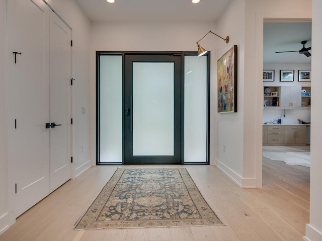 foyer featuring a ceiling fan, recessed lighting, baseboards, and wood finished floors