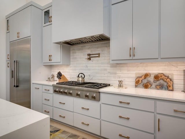 kitchen with premium range hood, appliances with stainless steel finishes, gray cabinetry, and decorative backsplash