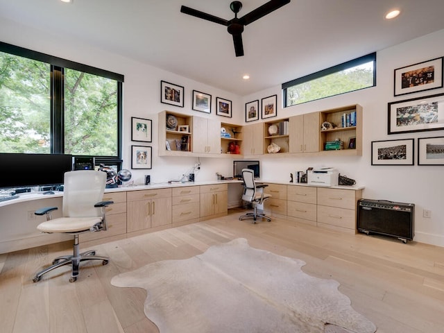 home office with light wood-style flooring, a ceiling fan, built in desk, and recessed lighting