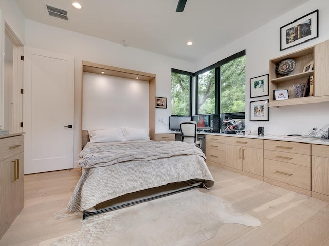 bedroom featuring visible vents, built in study area, light wood-style flooring, ceiling fan, and recessed lighting