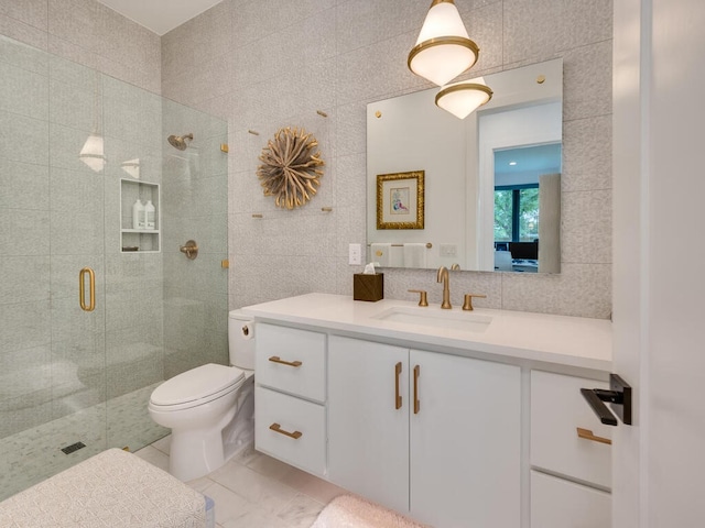 full bathroom featuring tile walls, decorative backsplash, toilet, a stall shower, and vanity