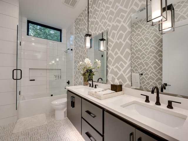 full bath featuring toilet, visible vents, tile walls, and a sink