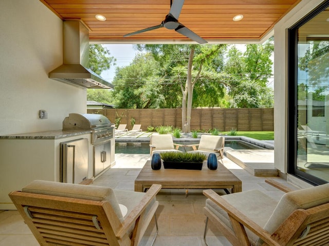 view of patio / terrace with a fenced backyard, ceiling fan, grilling area, and an outdoor kitchen