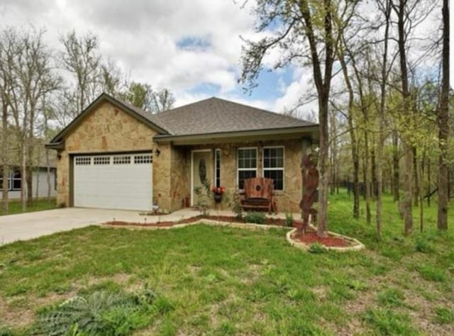 view of front of home with a garage, stone siding, driveway, and a front lawn