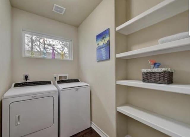 laundry area featuring laundry area, baseboards, visible vents, and washer and clothes dryer