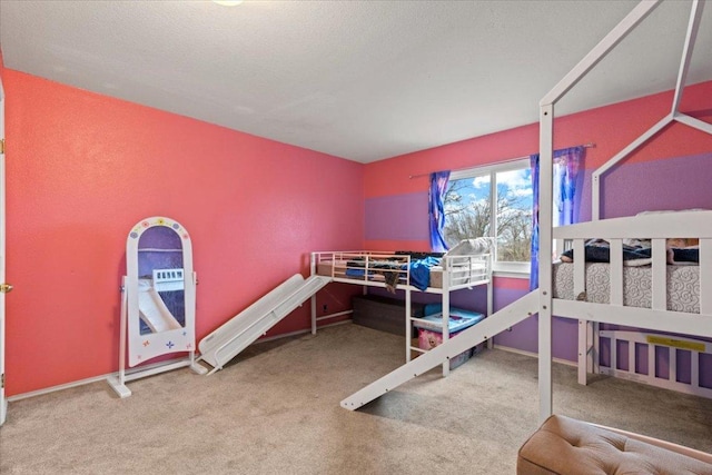 bedroom with a textured ceiling and carpet flooring