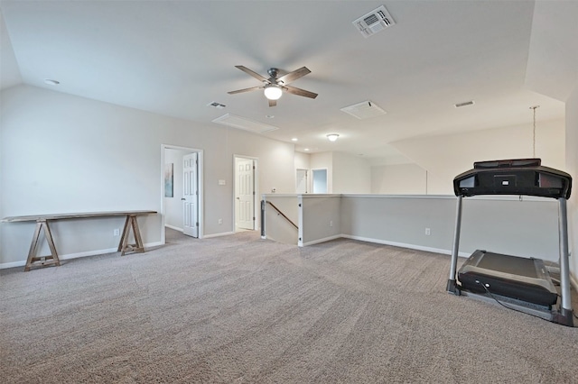 workout area featuring baseboards, attic access, visible vents, and carpet flooring