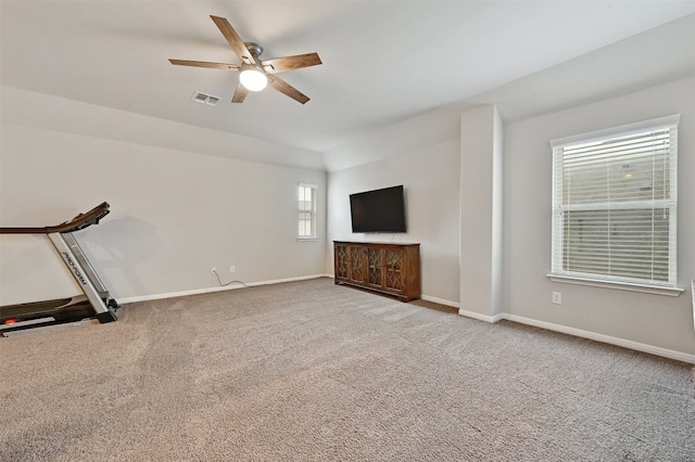 unfurnished living room featuring ceiling fan, carpet flooring, visible vents, and baseboards