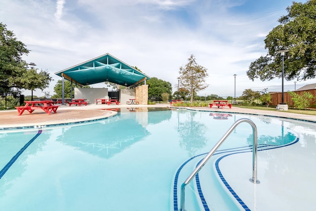 pool featuring a patio area and fence