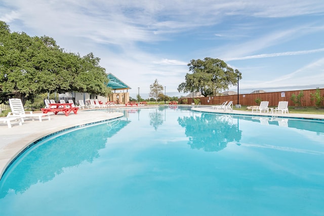 community pool featuring a patio area and fence