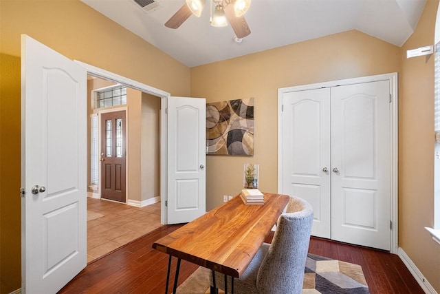 office with visible vents, baseboards, ceiling fan, vaulted ceiling, and dark wood-style floors