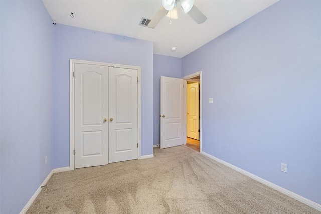 unfurnished bedroom featuring a closet, baseboards, visible vents, and carpet floors