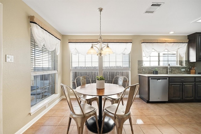 dining area featuring light tile patterned floors, visible vents, plenty of natural light, and baseboards