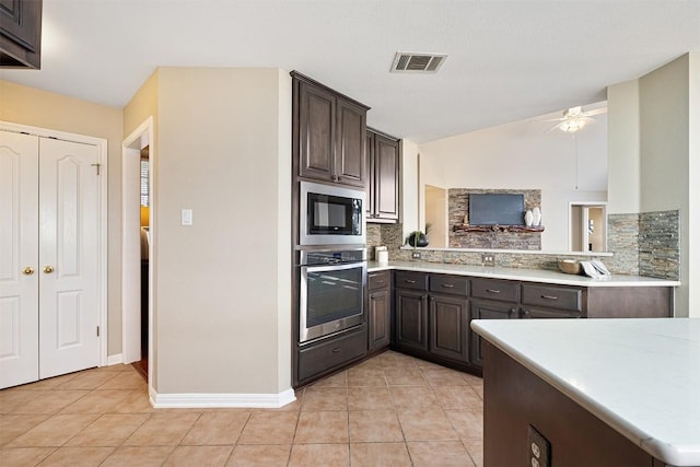 kitchen featuring visible vents, dark brown cabinets, light countertops, appliances with stainless steel finishes, and light tile patterned flooring