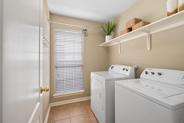 laundry room featuring washer and dryer, laundry area, light tile patterned floors, and baseboards