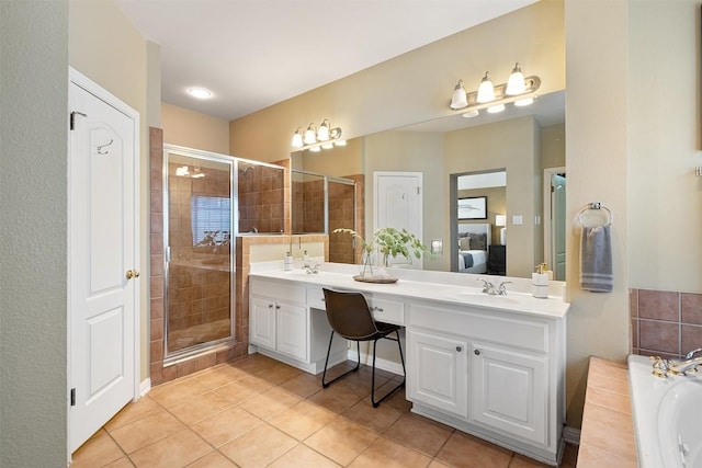 ensuite bathroom featuring a shower stall, a garden tub, double vanity, ensuite bath, and a sink