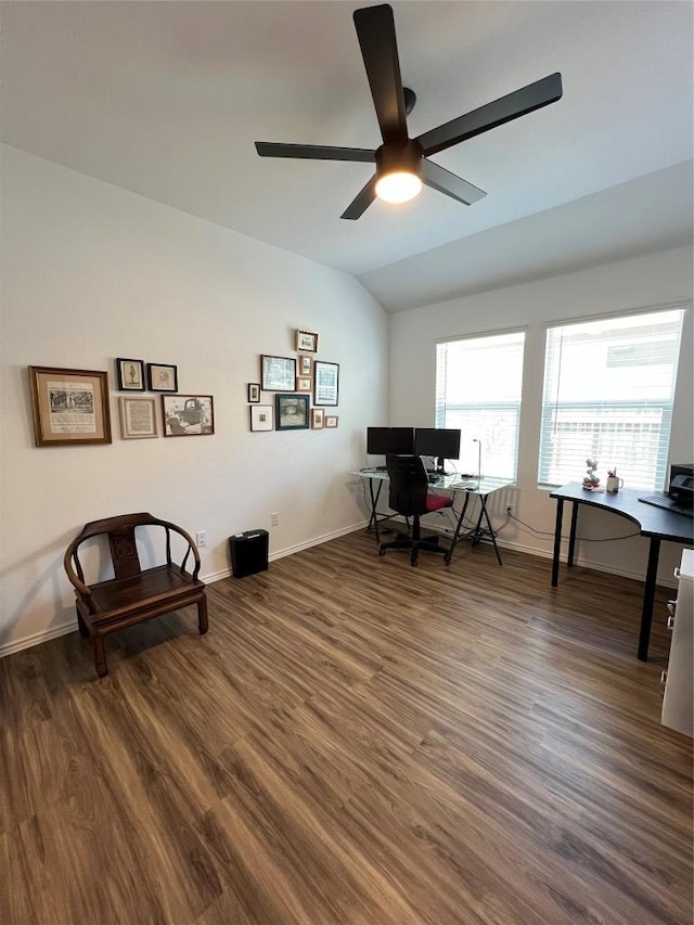 office area with dark wood-type flooring, lofted ceiling, ceiling fan, and baseboards