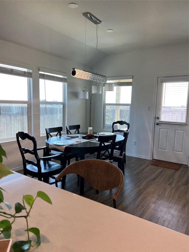 dining space with dark wood-style flooring and baseboards