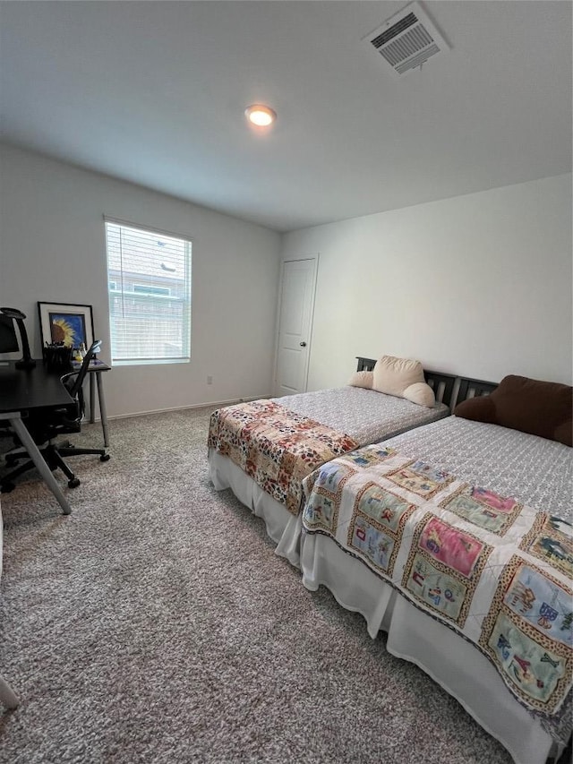 bedroom featuring baseboards, visible vents, and carpet flooring