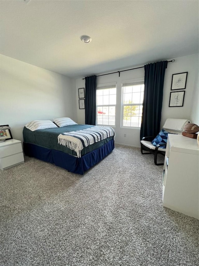 bedroom featuring carpet and baseboards