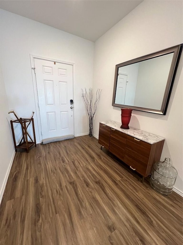 entryway featuring dark wood-style flooring and baseboards