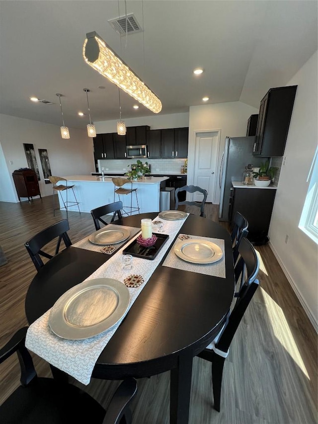 dining space with dark wood-type flooring, recessed lighting, visible vents, and baseboards